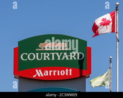Toronto Canada, June 17, 2020; The Courtyard by Marriott hotel roadside pillar sign on Woodbine Avenue with a Canadian flag Stock Photo