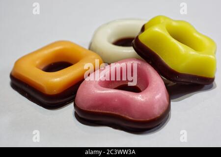 Assorted donuts in white, yellow, orange and pink colors Stock Photo