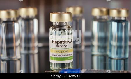 Vial of Hepatitis A injection with a syringe on a stainless steel background Stock Photo