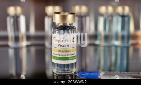 Vial of Hepatitis B vaccine with siringe on a stainless steel background Stock Photo