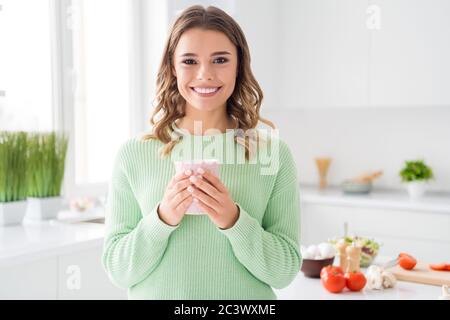 Close-up portrait of her she nice attractive lovely pretty cute charming cheerful cheery girl cooking fresh tasty yummy meal drinking sweet cacao in Stock Photo