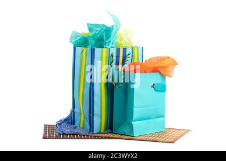 color coordinated blue gift bags with matching tissue paper isolated on white Stock Photo