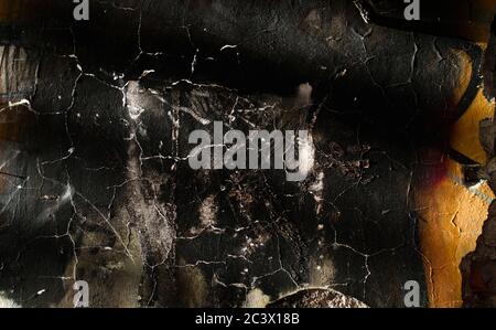Old burned wall with peeling paint Stock Photo