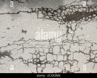 Texture of cracked road surface, asphalt with cracks, damaged road. Stock Photo