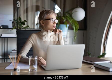 Businesswoman planning new creative ideas sitting at desk in office Stock Photo