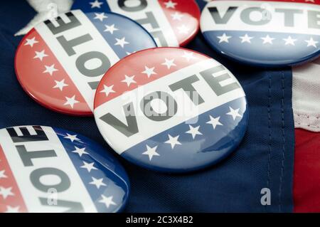 Democrat vs republican poll, democratic decision and primary voting conceptual idea with Vote election campaign button badges and the united states of Stock Photo