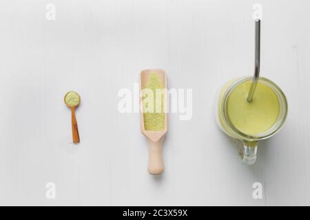 Matcha latte with coconut milk in jar glass on white background. Top view Stock Photo