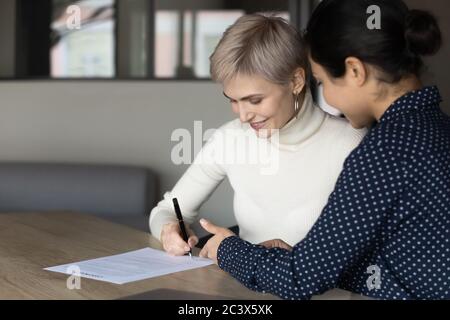 Applicant sign hiring agreement after successful job interview pass Stock Photo