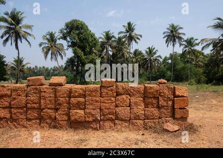 Stack of clay bricks in Goa, India. Stock Photo