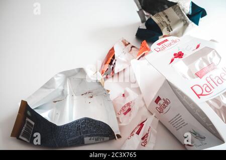 Lviv / Ukraine - April 2020: Assorted candy, cookie and chocolate wrappers left on a white table. Tasty sweets full of sugar that lead to health issue Stock Photo