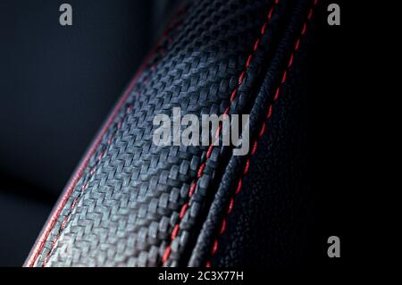 Luxury vehicles interior leather red stitching. Stock Photo