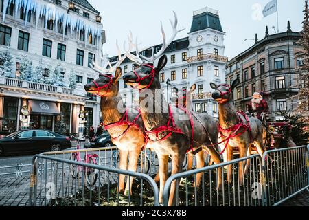 Copenhagen / Denmark - November 2019: Reindeer family with Santa Claus sleigh in the main square in Copenhagen. Scandinavian Christmas market. Stock Photo