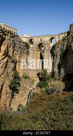 Puente Nuevo famous new bridge with archs in the heart of old village Ronda in Andalusia, Spain. Touristic landmark on a sunny day with buildings Stock Photo