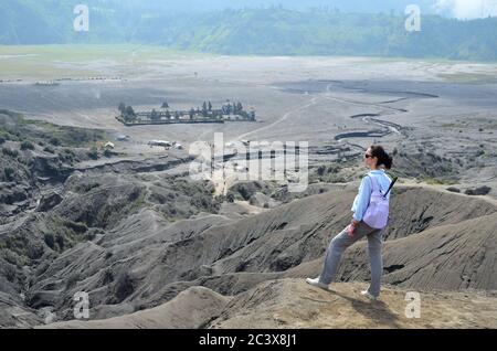 Woman on the top near volcano Bromo in Indonesia Stock Photo