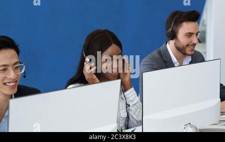 Team of hotline consultants working with computers at call centre Stock Photo