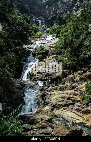 Ravana waterfall Sri Lanka. Crowded touristic spot called Ravana falls on a beautiful sunny day. Natural landmark in central Sri Lanka. Stock Photo