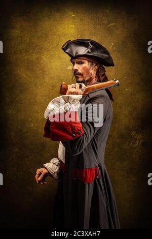 Portrait of a pirate, holding a musket gun in his hand Stock Photo