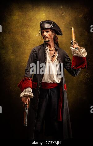 Portrait of a pirate, holding a musket gun in his hand Stock Photo