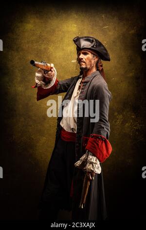 Portrait of a pirate, holding a musket gun in his hand Stock Photo