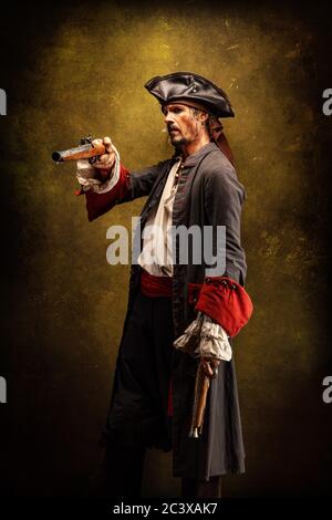 Portrait of a pirate, holding a musket gun in his hand Stock Photo