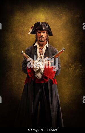 Portrait of a pirate, holding a musket gun in his hand Stock Photo