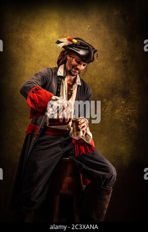 Portrait of a pirate drinking rum, sitting in a tavern Stock Photo - Alamy