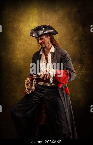 Portrait of a pirate drinking rum, sitting in a tavern Stock Photo - Alamy