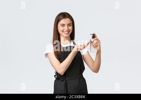 Grocery store employees, small business and coffee shops concept. Friendly cute barista guarantee all preventing virus measures are done, showing how Stock Photo