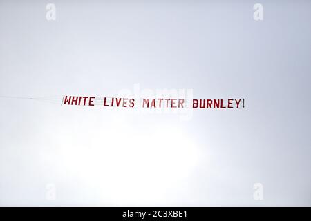 A plane flies over the stadium with a banner reading 'White Lives Matter Burnley' during the Premier League match at the Etihad Stadium, Manchester. Stock Photo