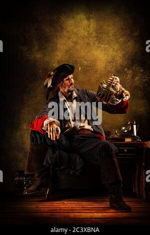 Portrait of a pirate drinking rum, sitting in a tavern Stock Photo - Alamy