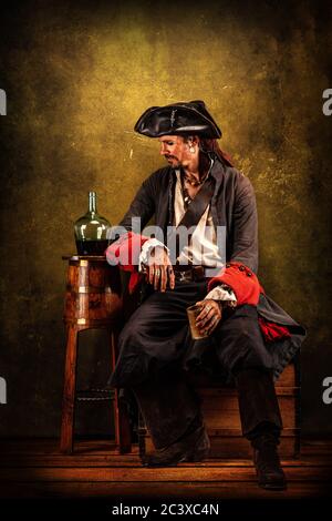 Portrait of a pirate drinking rum, sitting in a tavern Stock Photo - Alamy