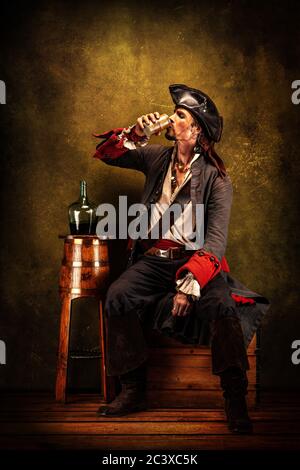 Portrait of a pirate drinking rum, sitting in a tavern Stock Photo - Alamy