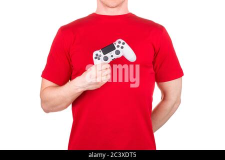 Man in red t-shirt holding video game joysticks gamepad on his palm isolated Stock Photo