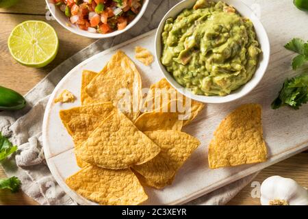 Homemade Tortillas Chips with Salsa and Guacamole with Lime Stock Photo