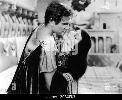 HENRY WILCOXON as Marc Antony and CLAUDETTE COLBERT as CLEOPATRA 1934 director CECIL B. DeMILLE Miss Colbert costume Travis Banton photo by Ray Jones Paramount Pictures Stock Photo