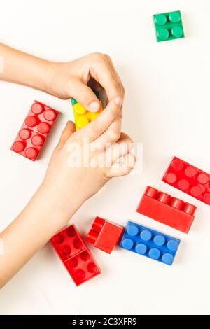 Children's hands collect the designer from cubes Stock Photo