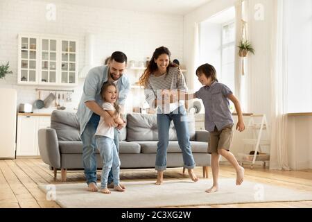 Happy family playing funny game having fun together.
