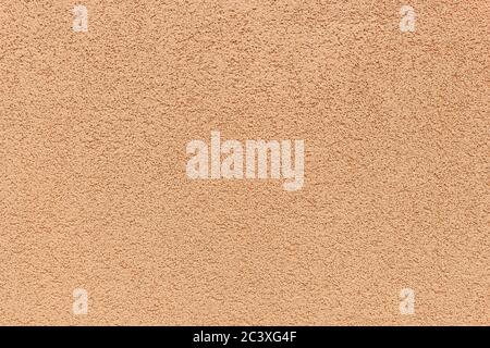 Texture of rustic exterior textured coating on the wall. Peach color, rustic exterior texture paint, background idea concept Stock Photo