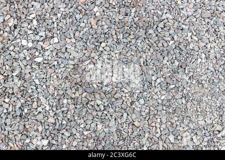 Texture of ballast of broken stone, chippings, macadam, scree. Background, top view. Stock Photo