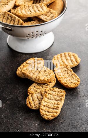 Rusk bread. Dried crispbread on kitchen table. Stock Photo