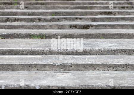 Old, wide and weathered gray concrete stairs structure. Stairway composition, texture, background Stock Photo