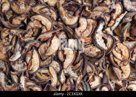 Scattered dried apple and pear slices texture. Pattern, dried slices background, texture close-up Stock Photo