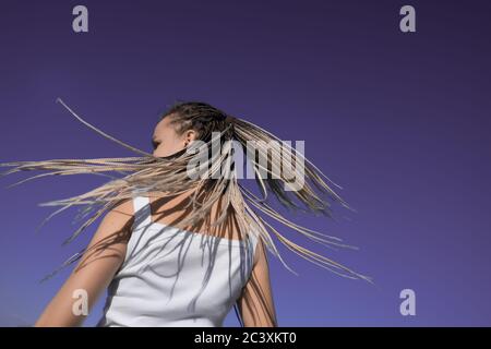 Beautiful woman waving hair with stylish afro braids Stock Photo