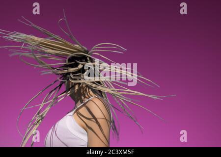 Attractive blonde woman shake head with afro braids Stock Photo