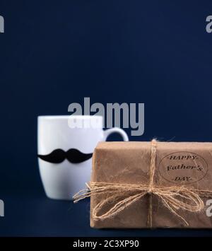 Happy fathers day concept. cup of coffee with black paper mustache, gift.  Stock Photo