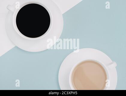 Double coffee in close-up Two cups of black coffee and coffee with milk are standing on a light blue background Photo with copy space Stock Photo