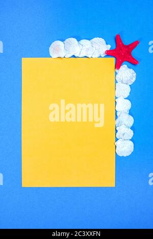 Starfish and seashells on a blue background with white plank page Stock Photo