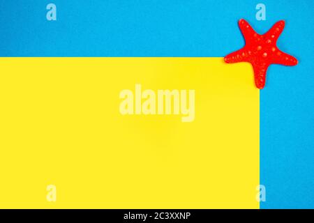 Red starfishes on a blue and yellow background Stock Photo