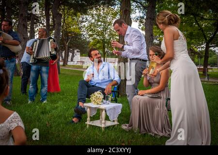 Wedding in Bulgaria. The bride and groom must serve their best man and maid of honor Stock Photo
