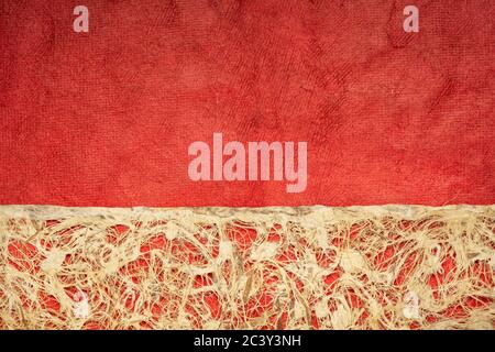 Amate bark paper with lace design against red huun paper.  This ancient paper dates back to pre-Columbian and Meso-American times and is still hand ma Stock Photo